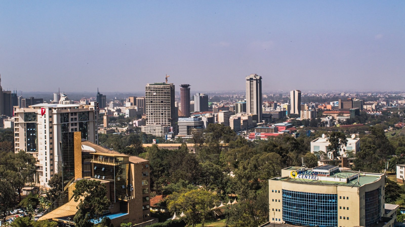Nairobi's skyline seen from above, with modern skyscrapers set against lush greenery