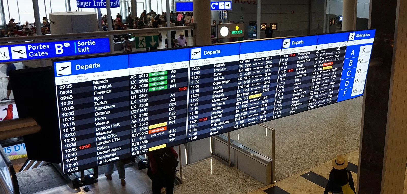 Departure board at Geneva Airport showing flight times and gates